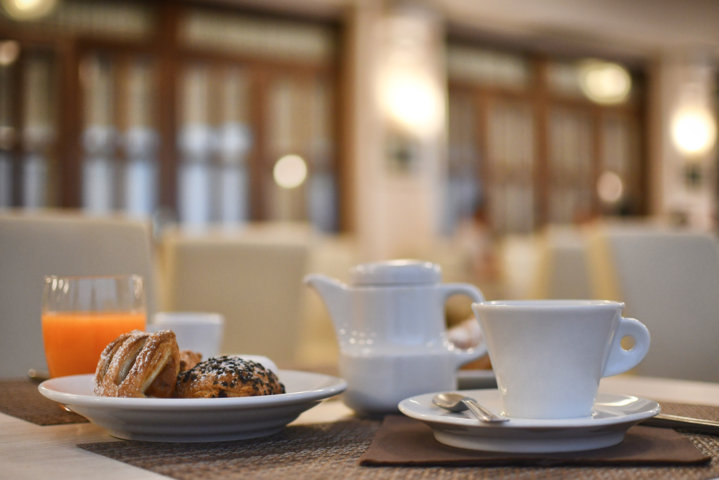 Colazione-dolce-a-tavola-al-tavolo-tè-the-tisane-tisana-caffè-coffee-espresso-cappuccino-succo-di-frutta-juice-fruit-saccottino-con-marmellata-cioccolato-croissant-breakfast